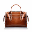 Elegant top handle bag in rich brown leather displayed on a minimalist black pedestal
