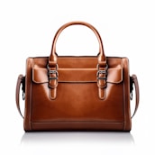 A brown leather handbag with a structured rectangular shape is prominently displayed. It features two handles and buckle accents on the front, highlighting a classic and elegant design. The stitching is visible along the edges, adding to the refined appearance.