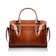 A brown leather handbag with a structured rectangular shape is prominently displayed. It features two handles and buckle accents on the front, highlighting a classic and elegant design. The stitching is visible along the edges, adding to the refined appearance.