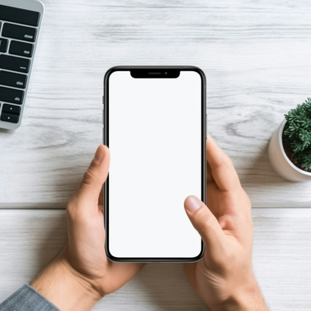 a person holding a phone with a white screen