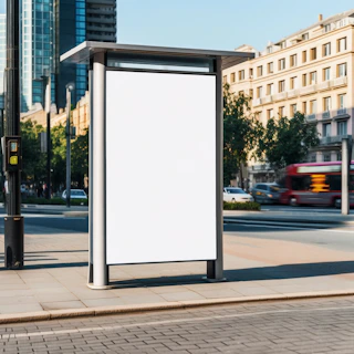 a bus stop with a white sign on the side of it