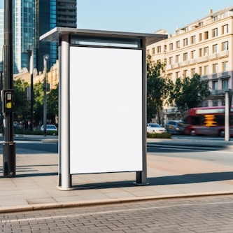 a bus stop with a white sign on the side of it