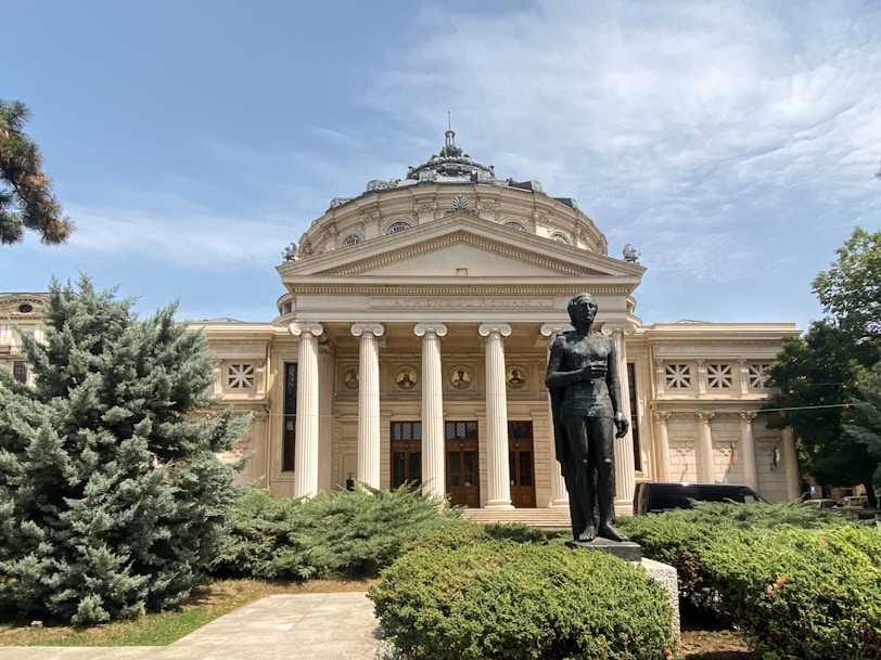 a statue of a man in front of a building