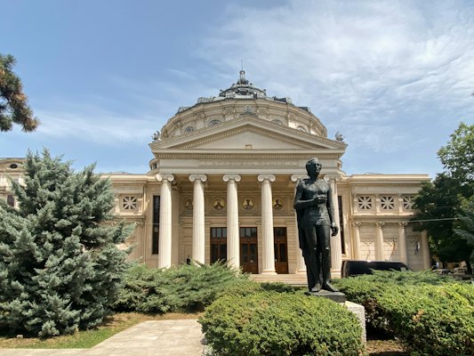 A statue of a man in front of a building — Bucharest, Romania