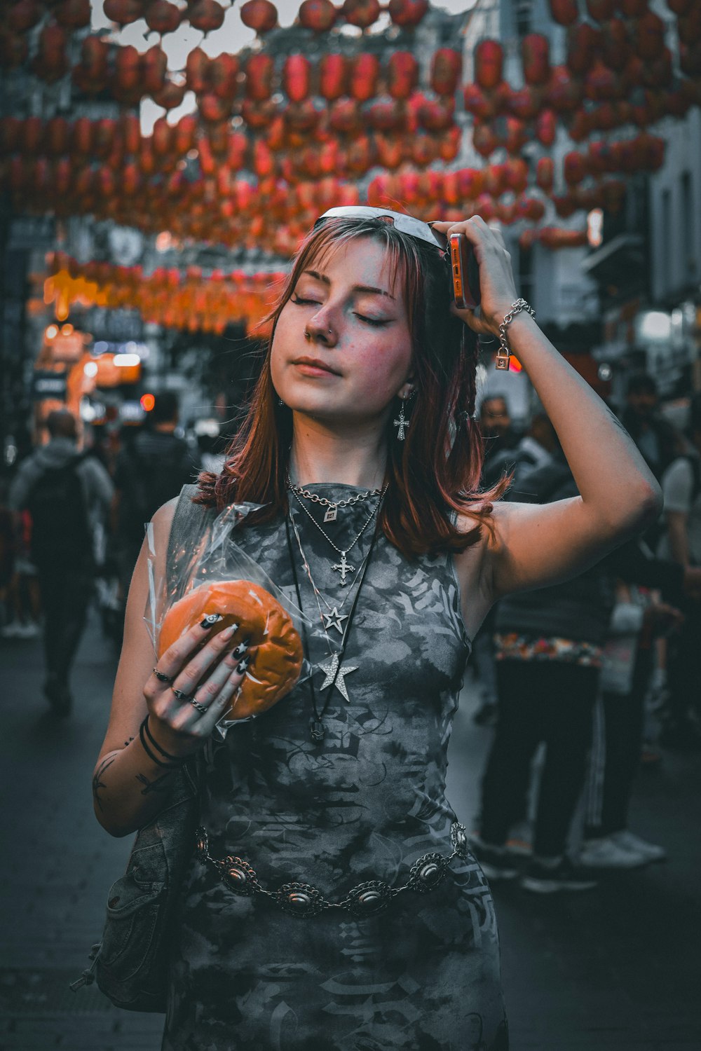 a woman holding a donut in her right hand