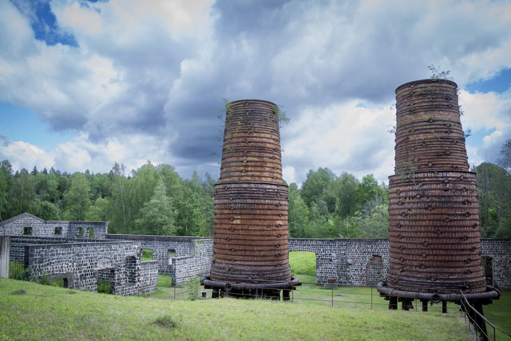 a couple of large brick structures in a field