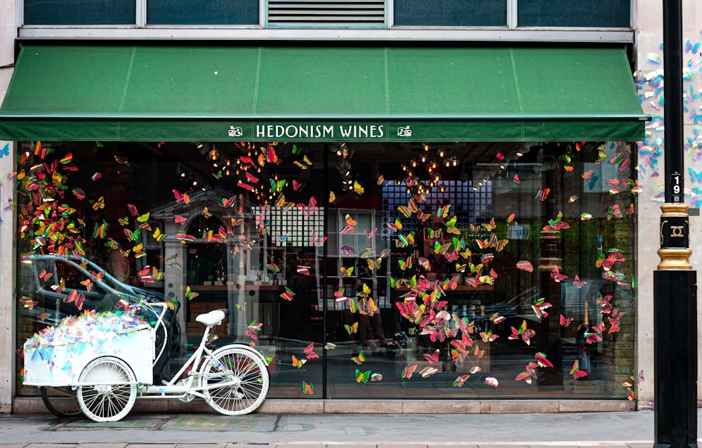 a bicycle parked in front of a store front