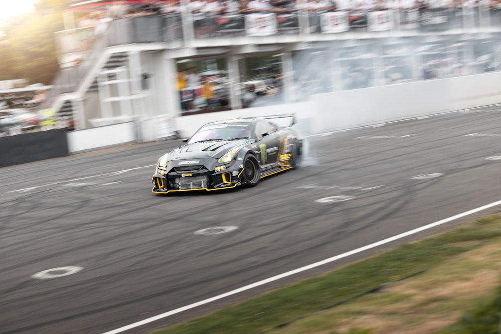 a car driving down a race track with smoke coming out of it