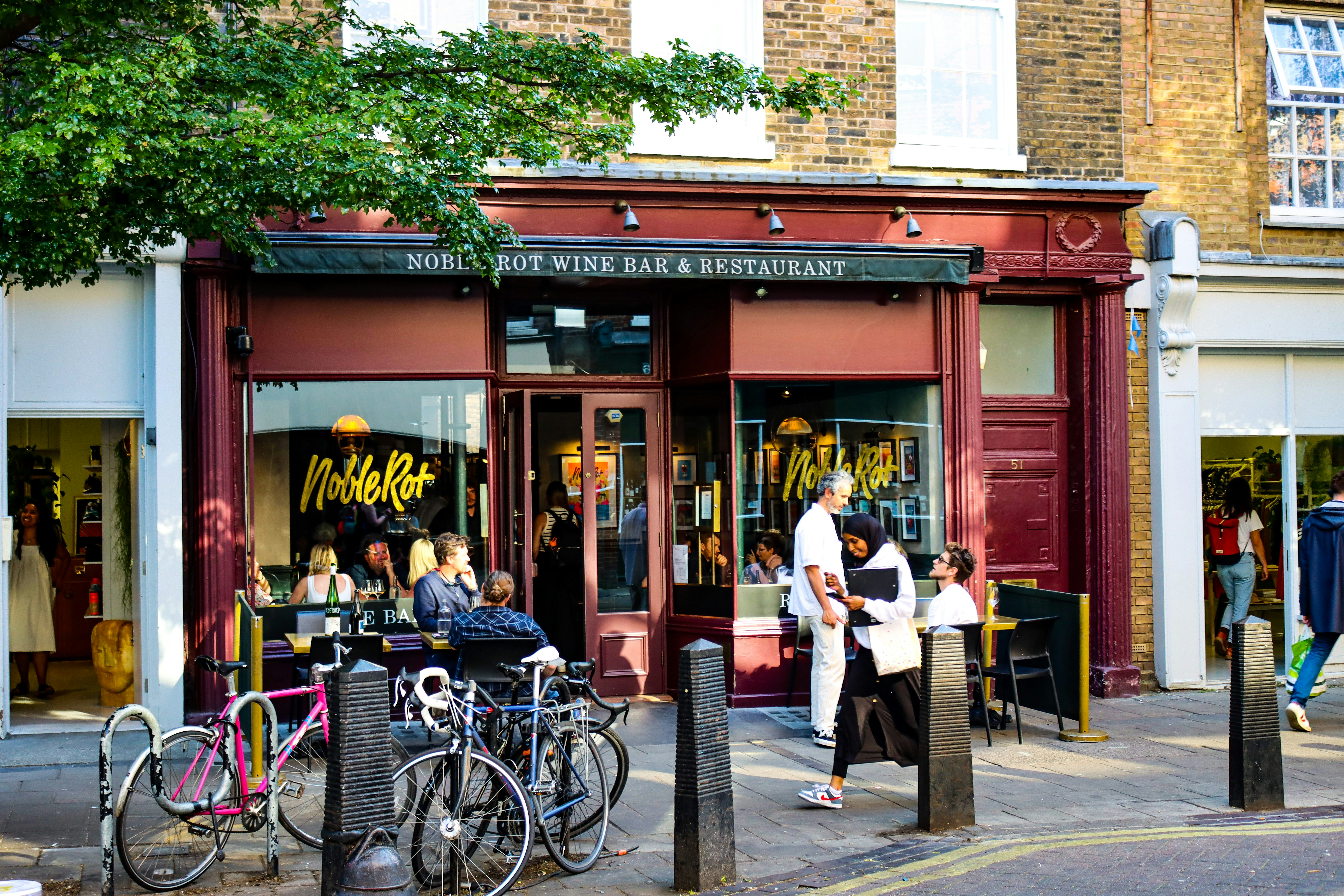 a group of people standing outside of a store