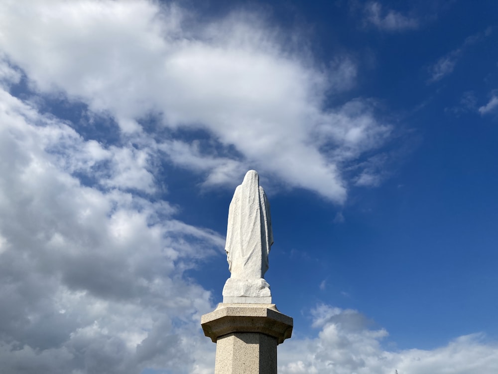 a statue of a person with a cross on it