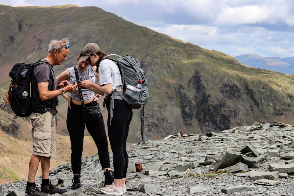 a group of people standing on top of a mountain