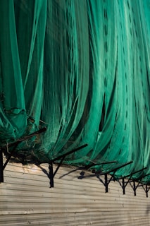 Wide shot showing a freshly installed safety net covering a large apartment duct opening.