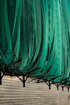 Bird netting covering a large warehouse area, keeping birds away from stored goods.