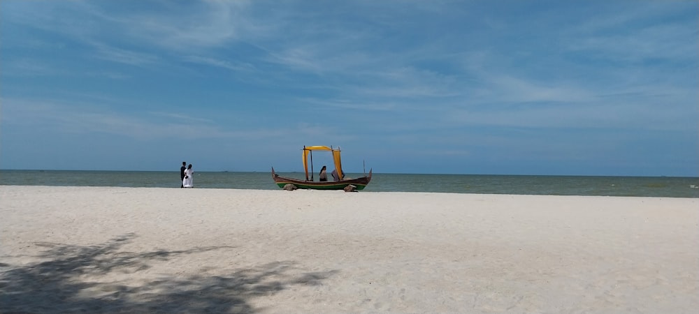 a boat sitting on top of a sandy beach