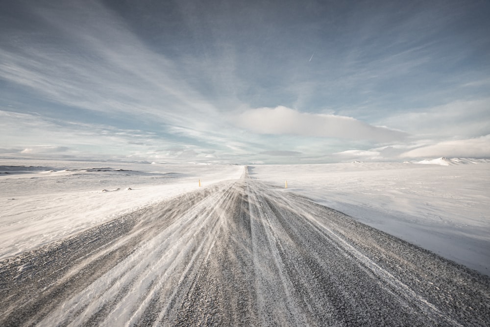 a snow covered road in the middle of nowhere