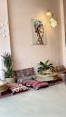 A cozy common area filled with colorful cushions and art.