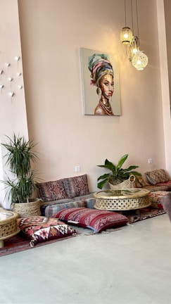 A cozy common area filled with colorful cushions and art.