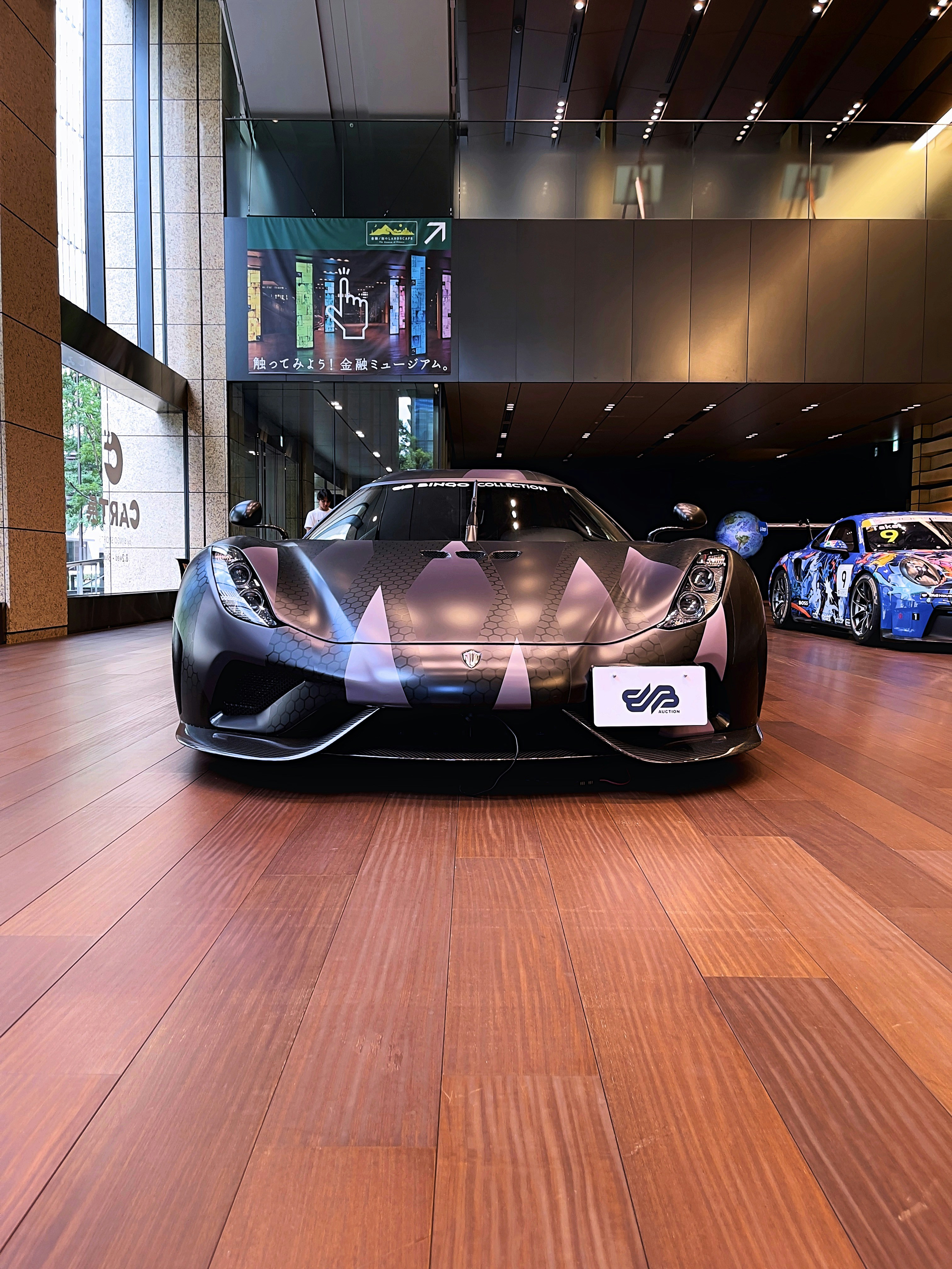 A sports car on display in a building photo – Free Koniegsegg Image on ...