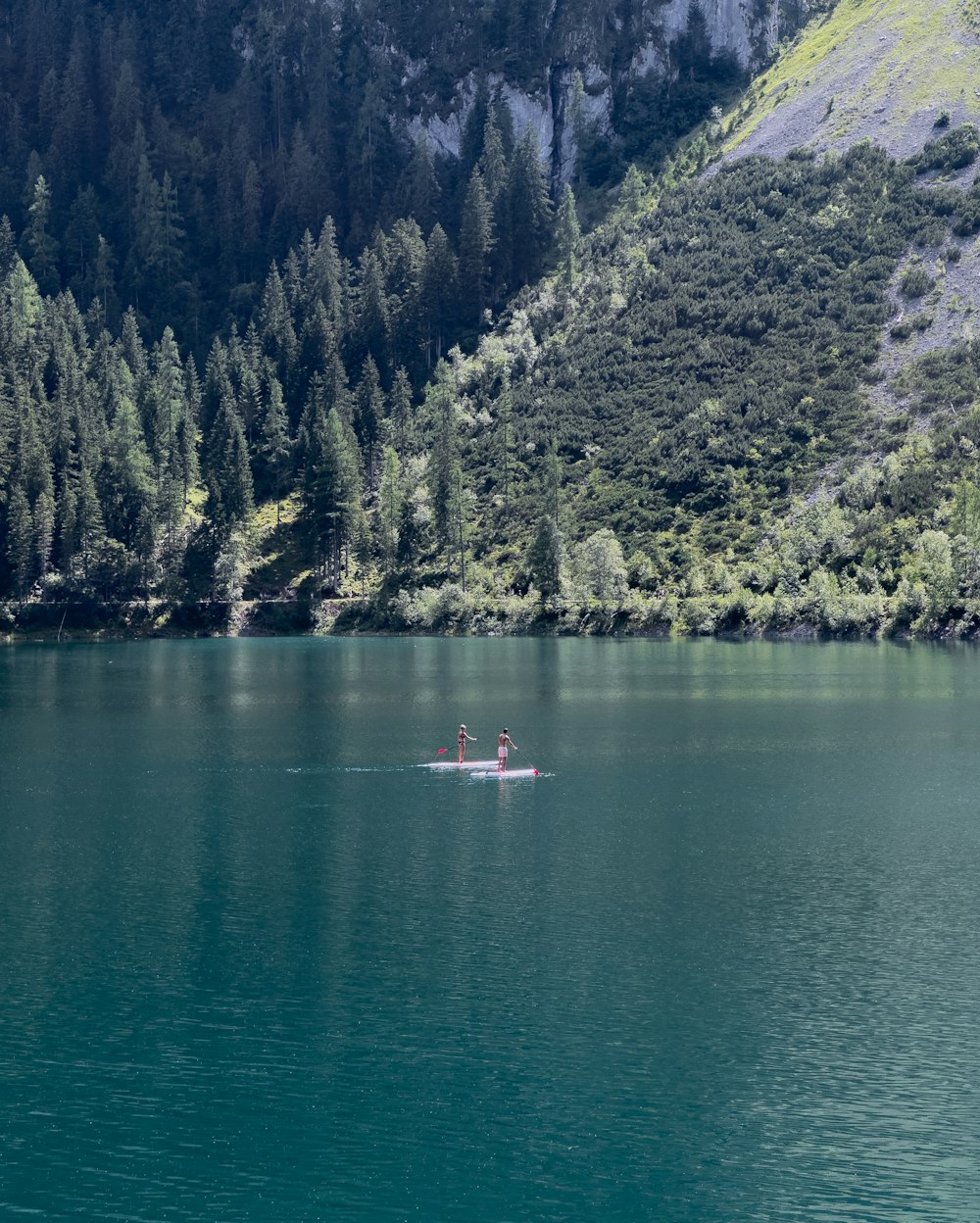 a man is rowing a boat on a lake