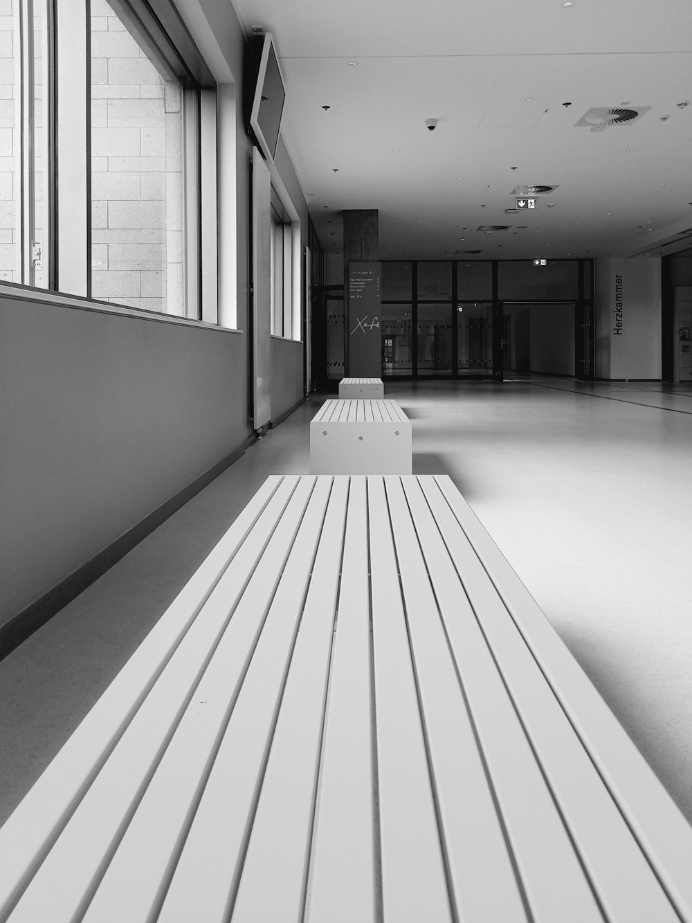 a white bench sitting in the middle of a room