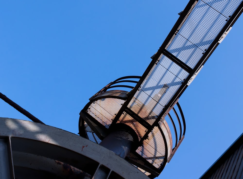 a tall metal tower with a blue sky in the background