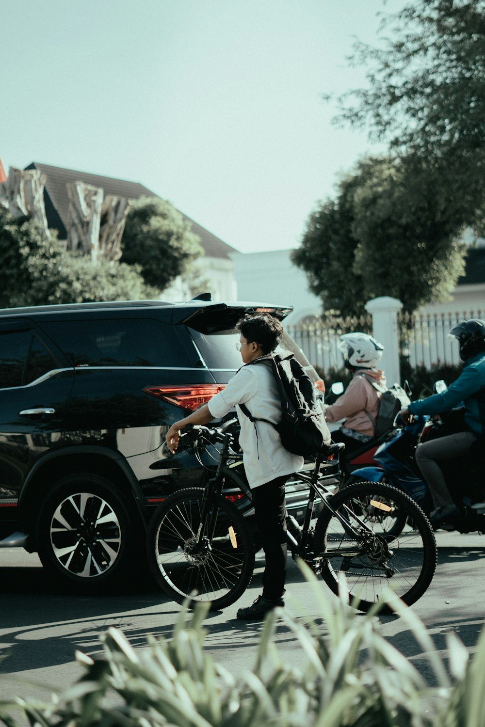 a woman riding a bike down a street