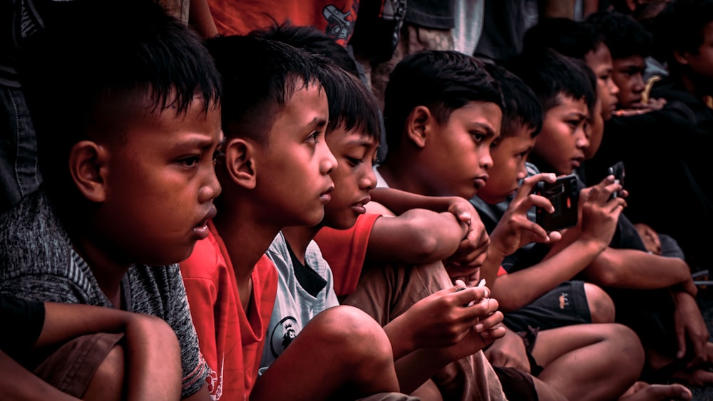 a group of young boys sitting next to each other