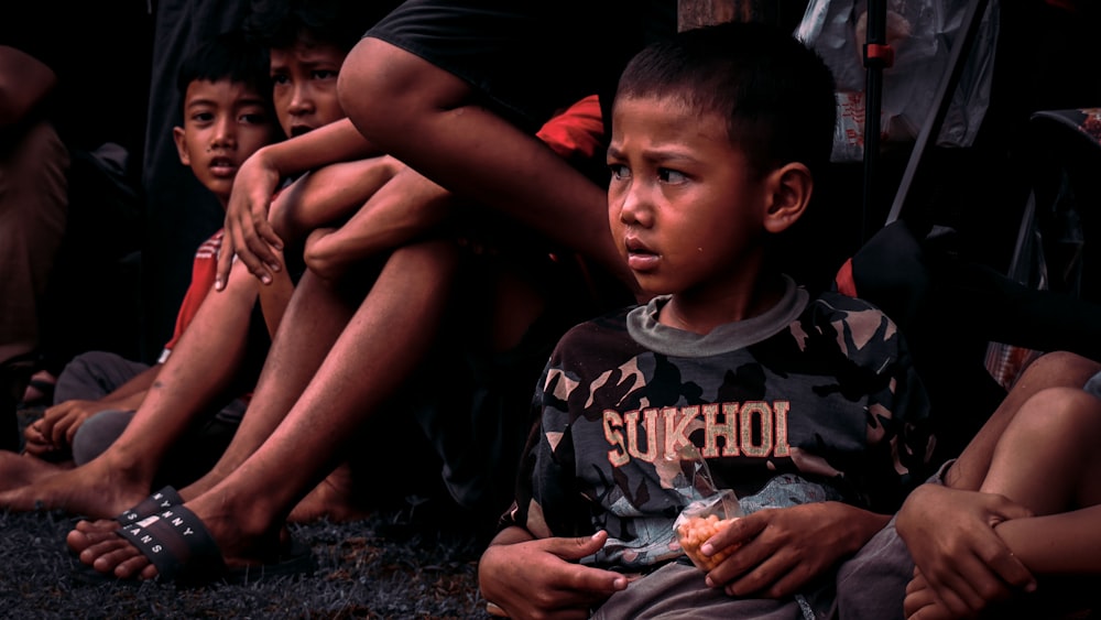 a group of young boys sitting next to each other