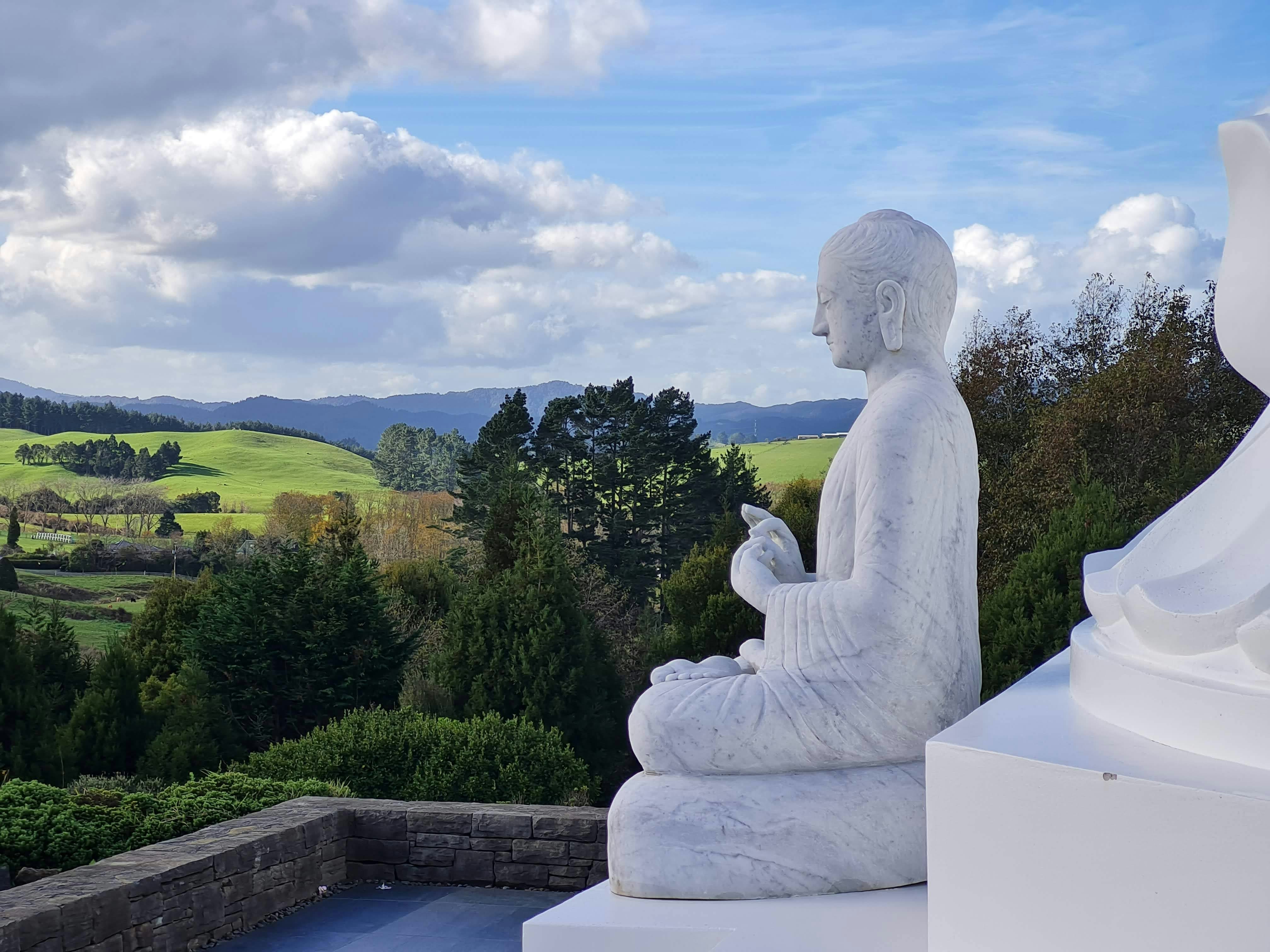 a statue of a person sitting in a lotus position