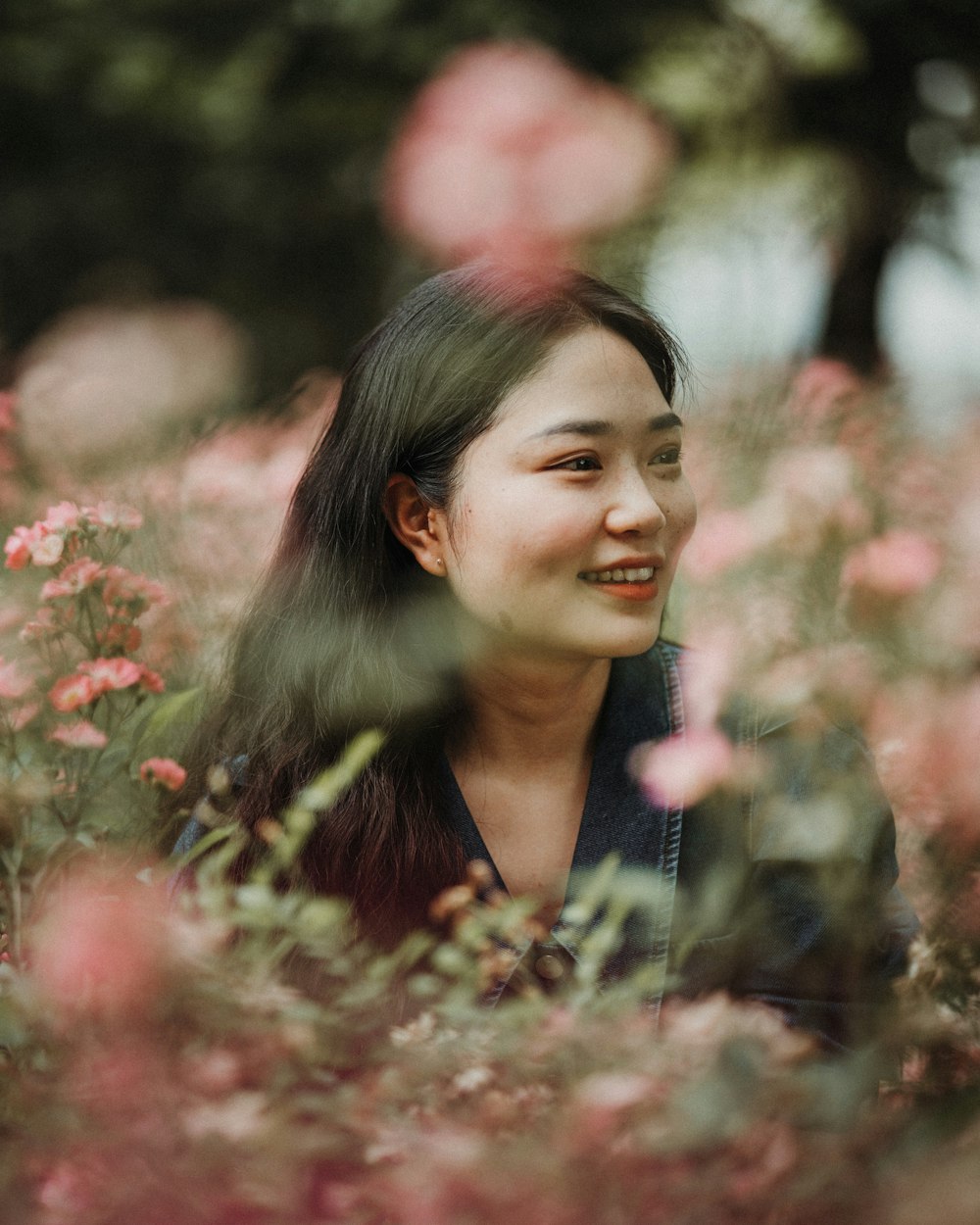 a woman standing in a field of flowers