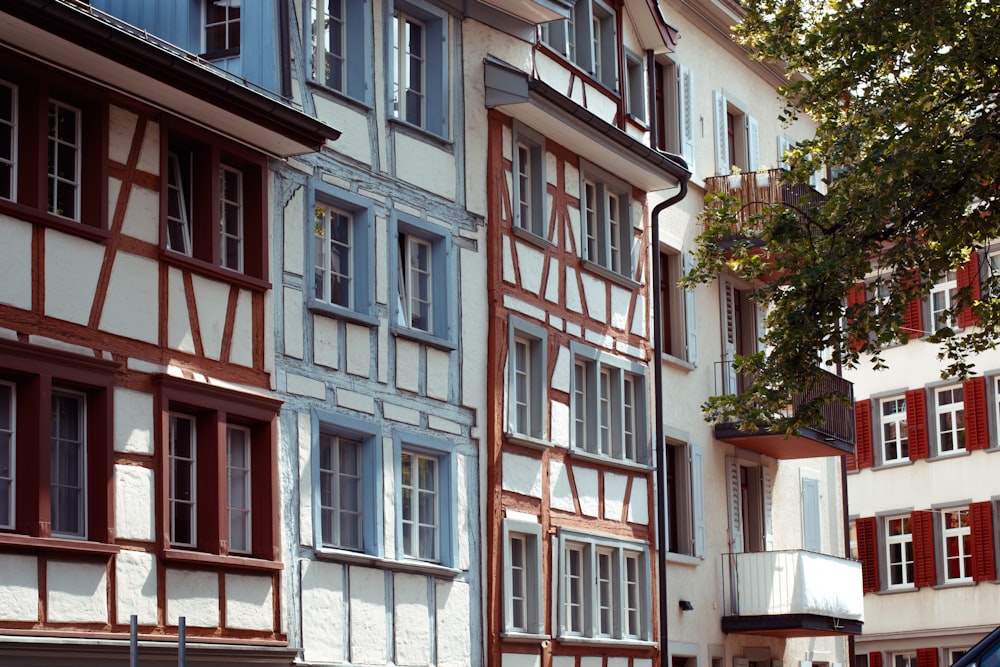 a car is parked in front of a row of multi - colored buildings