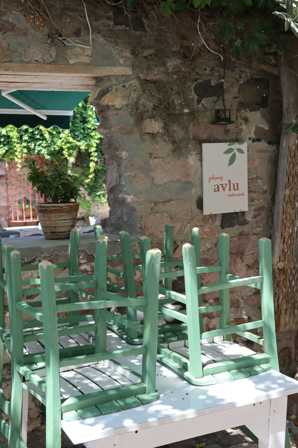 a couple of green chairs sitting on top of a white table