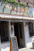 Exterior view of the Cádiz shop with welcoming signage and a sunny Andalusian street scene.