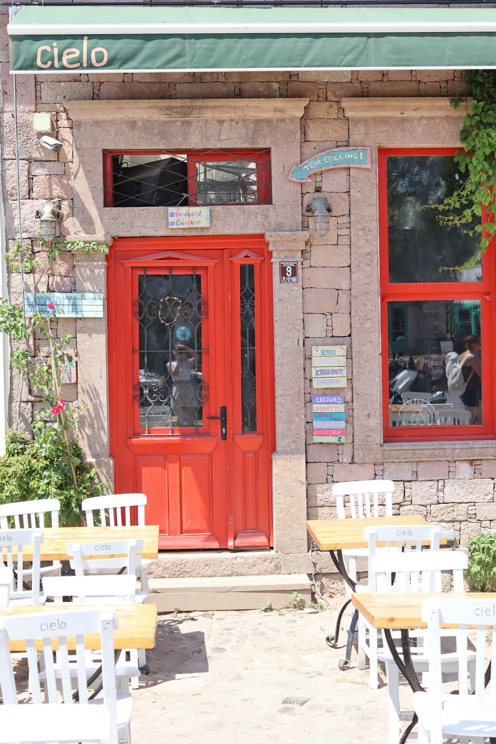 a restaurant with tables and chairs outside of it