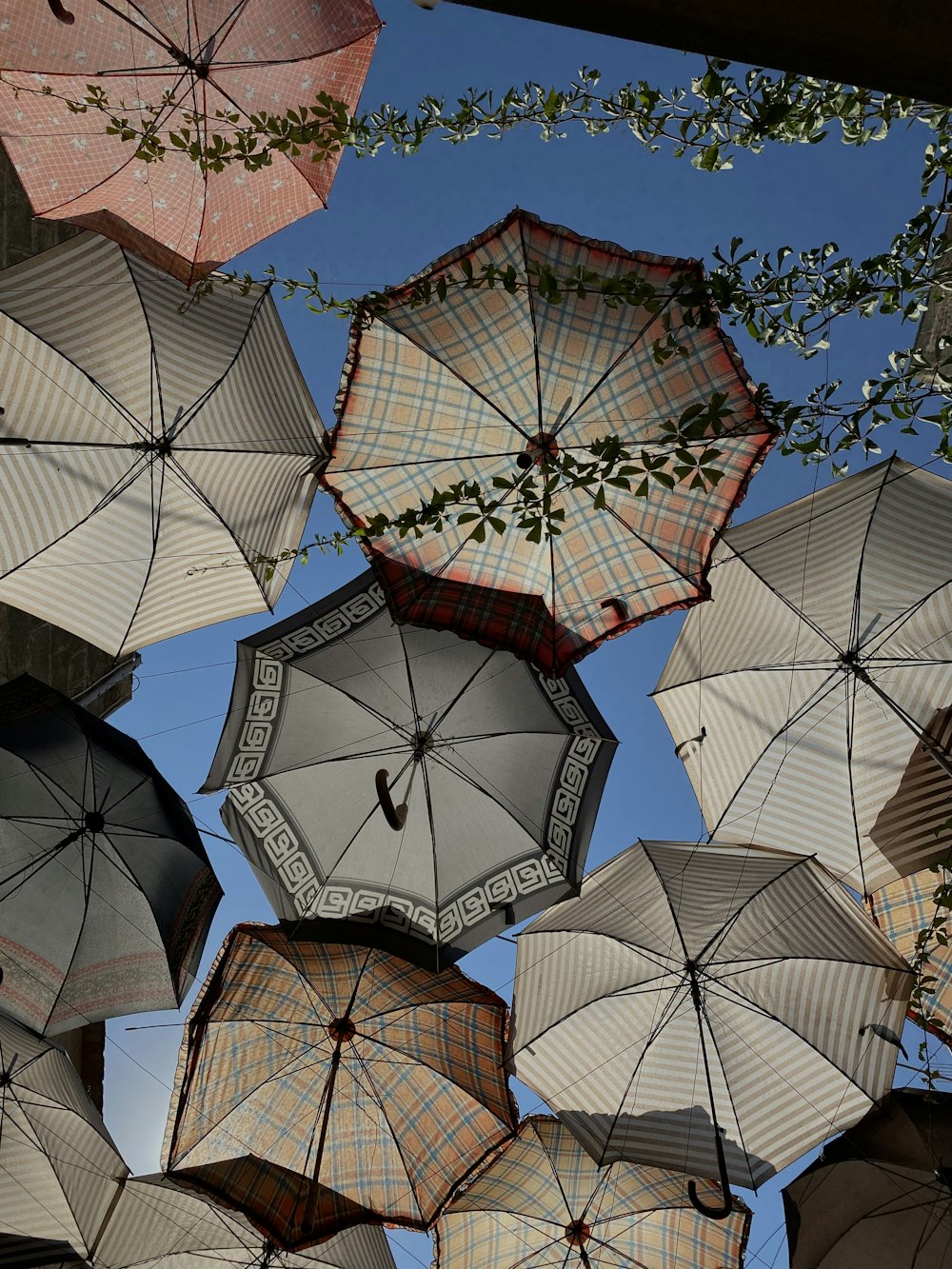 a bunch of umbrellas that are hanging in the air