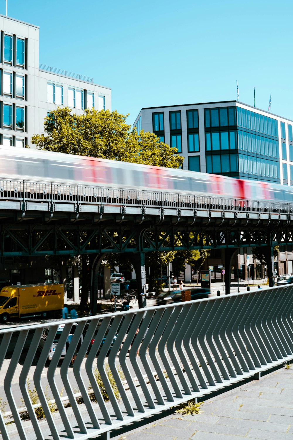 a train traveling over a bridge next to tall buildings