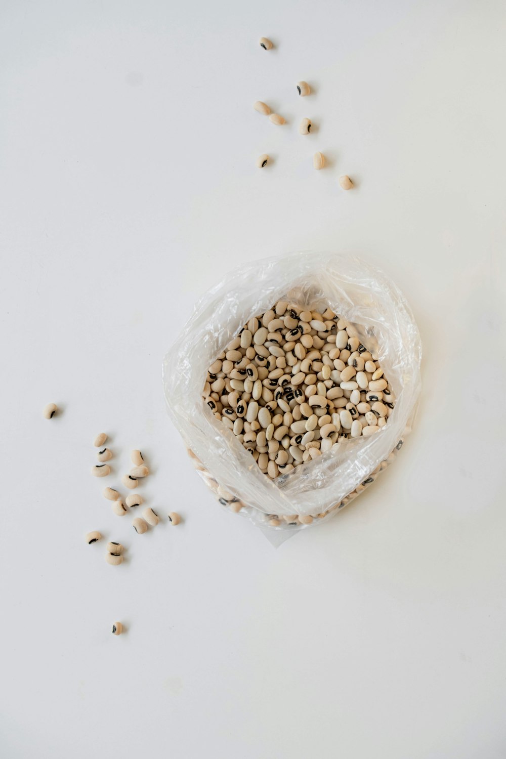 a bag filled with seeds on top of a white table