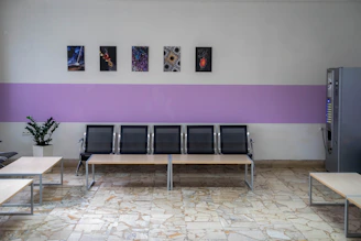 a row of benches sitting next to a wall