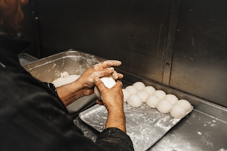 a person in a kitchen preparing food on a tray