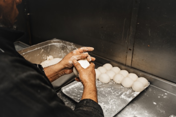 a person in a kitchen preparing food on a tray