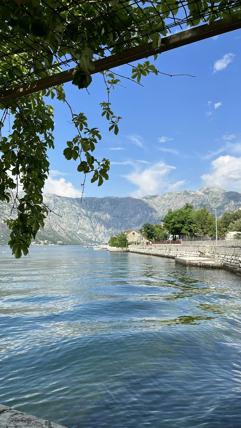 a view of a body of water with mountains in the background