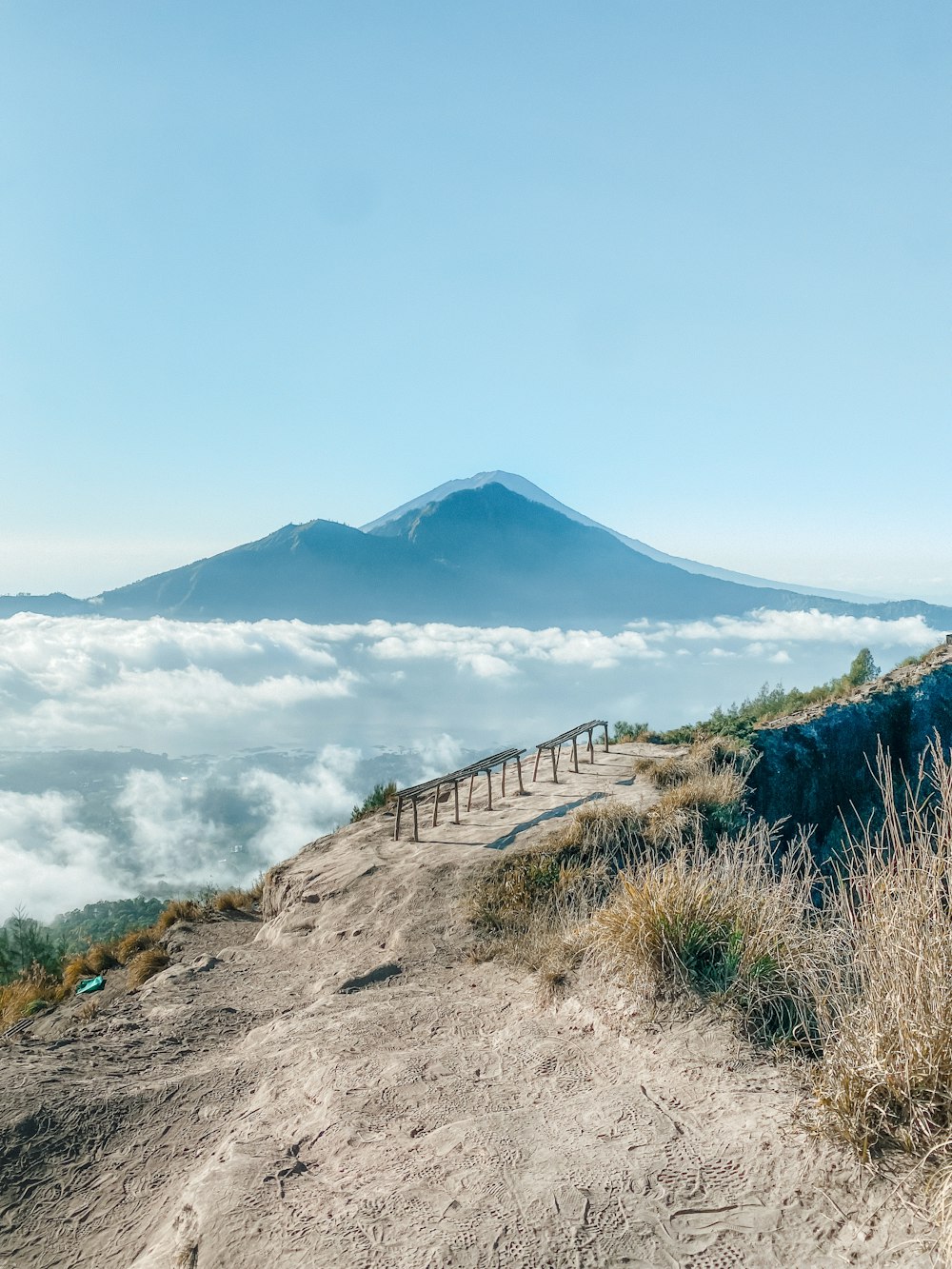 a view of the top of a mountain in the clouds