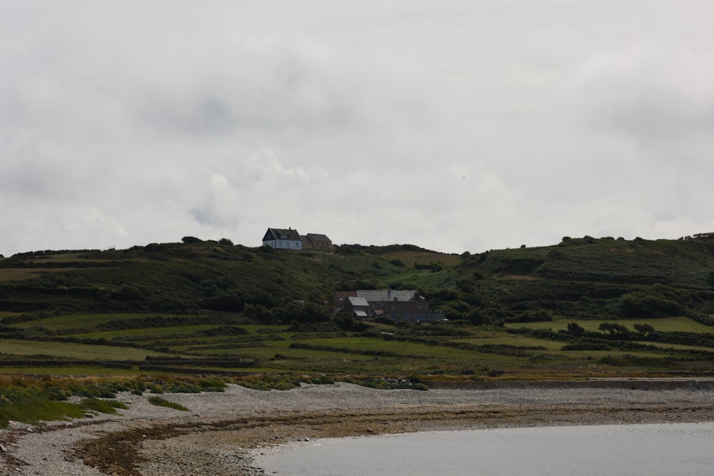a house on a hill overlooking a body of water