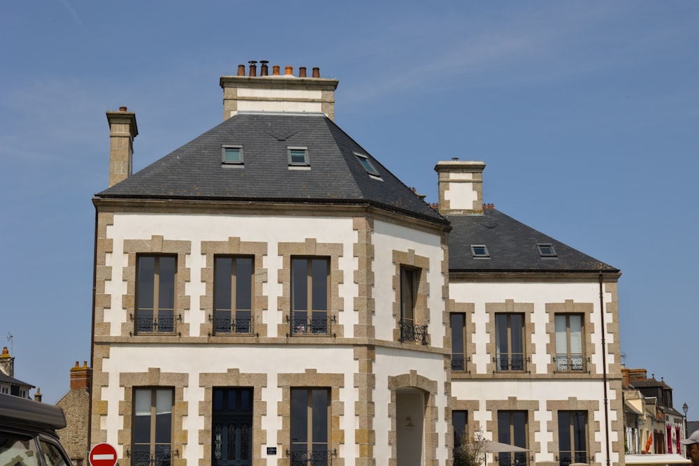 a large white building with a black roof