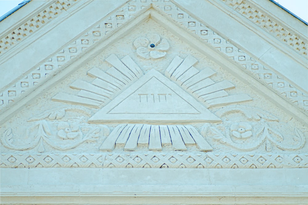 a close up of a building with a triangle