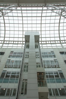 a tall white building with a skylight above it