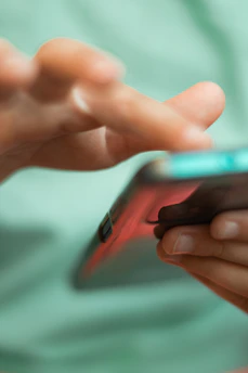 Close-up of a hand interacting with a futuristic AI chatbot on a smartphone screen.