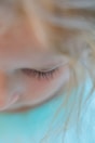 a close up of a woman's eye with long eyelashes