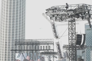 A wide shot of a metal structure being assembled at a concert.