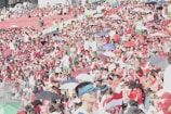A sea of red and green flags waving in the stadium stands.